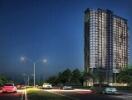 High-rise apartment building at night with street view