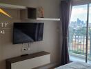 Bedroom with balcony view and wall-mounted television