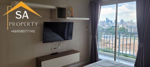 Bedroom with balcony view and wall-mounted television