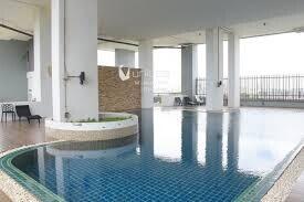 Indoor pool area with large windows and seating