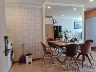 Modern dining area with table, chairs, mirror, and decor