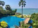 View of swimming pool, landscaping, and ocean beyond