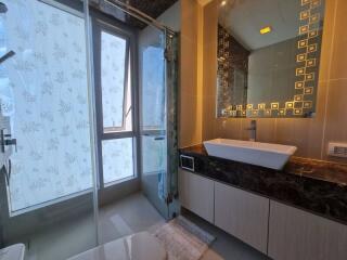 Modern bathroom with large window and stylish vanity