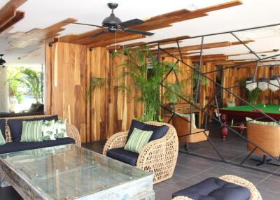 Modern living area with wooden accents and pool table