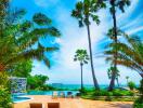 Scenic view of a pool area with palm trees and ocean in the background