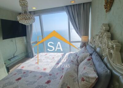 Bedroom with a sea view featuring a chandelier and ornate bed