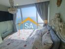 Bedroom with a sea view featuring a chandelier and ornate bed