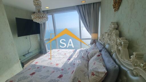 Bedroom with a sea view featuring a chandelier and ornate bed