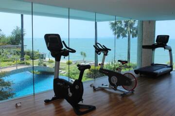 Sea-view fitness room equipped with exercise bikes and a treadmill