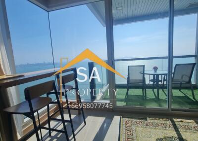 Living area leading to a balcony with a sea view