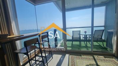 Living area leading to a balcony with a sea view