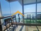 Living area leading to a balcony with a sea view