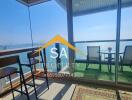 Bright living area with large windows and balcony overlooking the sea