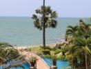 Beachfront view with pool and palm trees