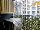 Balcony view with plants and nearby buildings