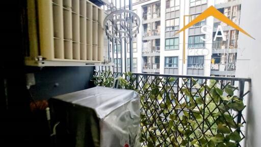 Balcony view with plants and nearby buildings