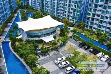 Aerial view of modern apartment complex with pool and parking area