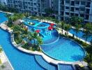 Aerial view of a building with a large outdoor swimming pool