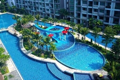 Aerial view of a building with a large outdoor swimming pool