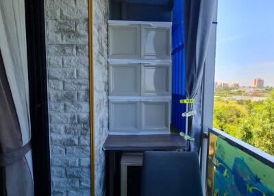 Small balcony or storage area with stacked cabinets and a chair