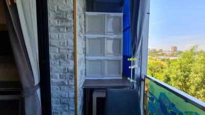 Small balcony or storage area with stacked cabinets and a chair