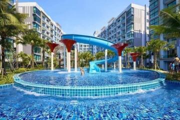 Outdoor area with swimming pool and water slide at a residential complex