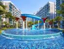 Outdoor area with swimming pool and water slide at a residential complex