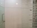 Modern bathroom with glass shower door and rainfall showerhead