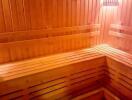 Wood-paneled sauna room with bench seating