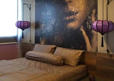 Bedroom with artistic wall decor and unique lighting