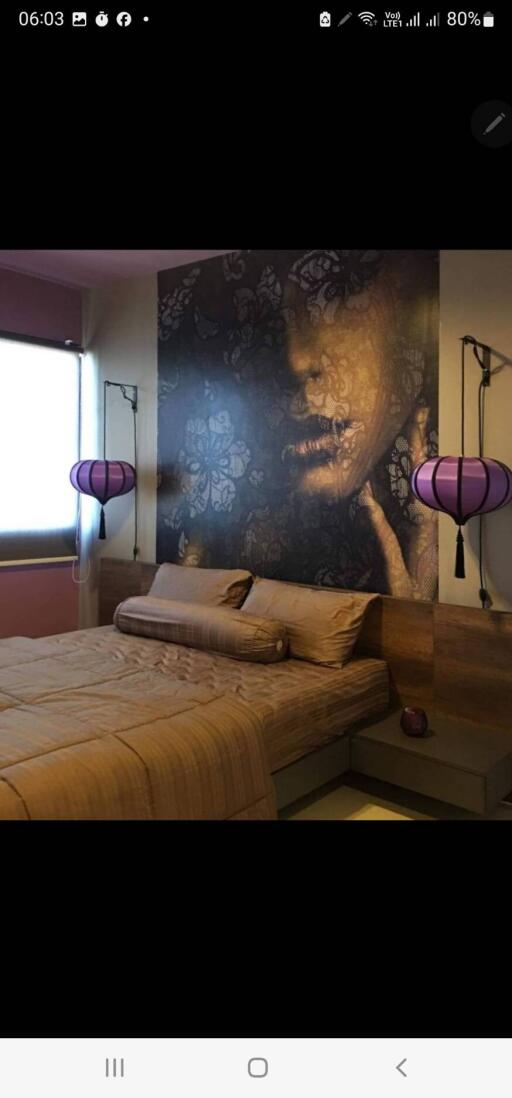 Bedroom with artistic wall decor and unique lighting