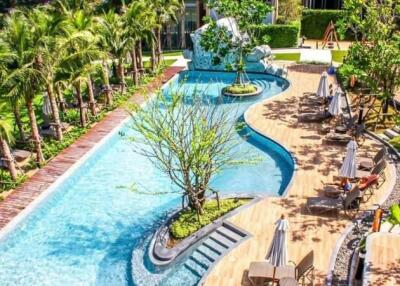 outdoor swimming pool and relaxation area with sunbeds and greenery