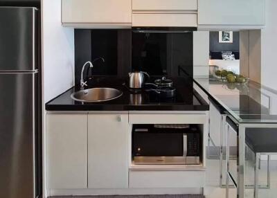 Modern kitchen with white cabinetry and stainless steel appliances