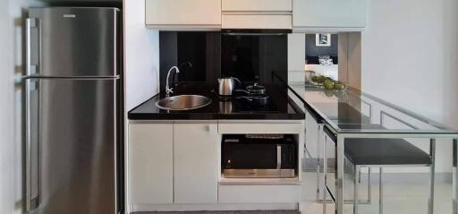 Modern kitchen with white cabinetry and stainless steel appliances