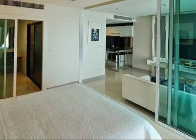 Modern bedroom with glass partition and open living area