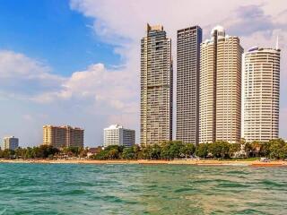 Skyscrapers along a beachfront with sea foreground