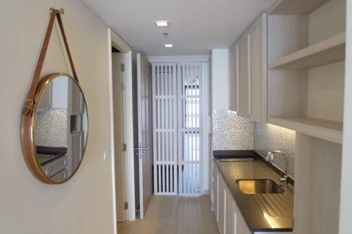 Modern hallway with wall mirror, recessed lighting, and built-in cabinetry