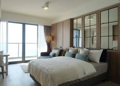 Spacious bedroom with a large window and modern decor