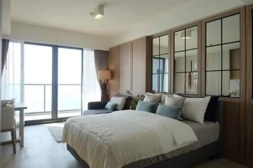 Spacious bedroom with a large window and modern decor