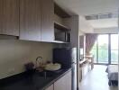 Modern kitchen area leading to a cozy living space