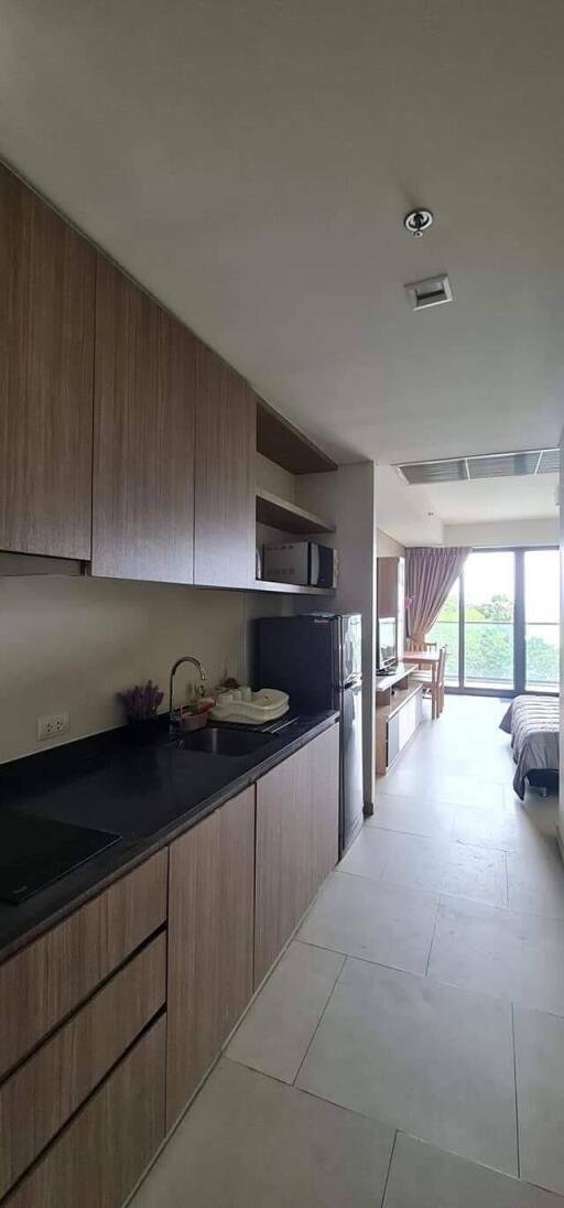 Modern kitchen area leading to a cozy living space