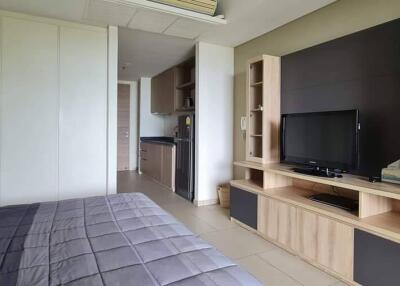 Spacious bedroom with attached kitchenette and entertainment unit