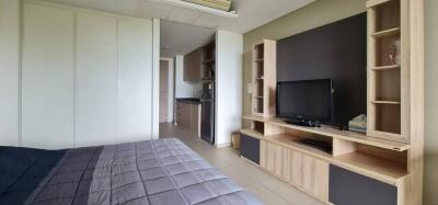 Spacious bedroom with attached kitchenette and entertainment unit