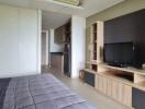 Spacious bedroom with attached kitchenette and entertainment unit