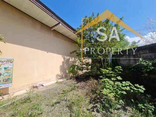 Outdoor area with building facade and vegetation