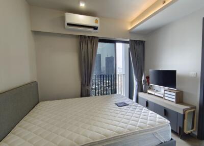 Bedroom with balcony, air conditioning, and modern furnishings