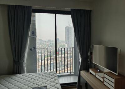 Bedroom with a large window and city view