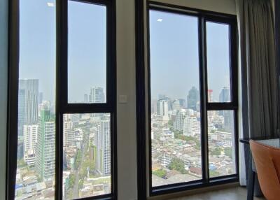 Modern living area with large windows offering city view