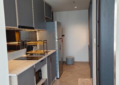 Modern kitchen with grey cabinets and wood flooring