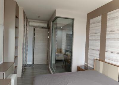 Modern bedroom with built-in storage and glass-enclosed area